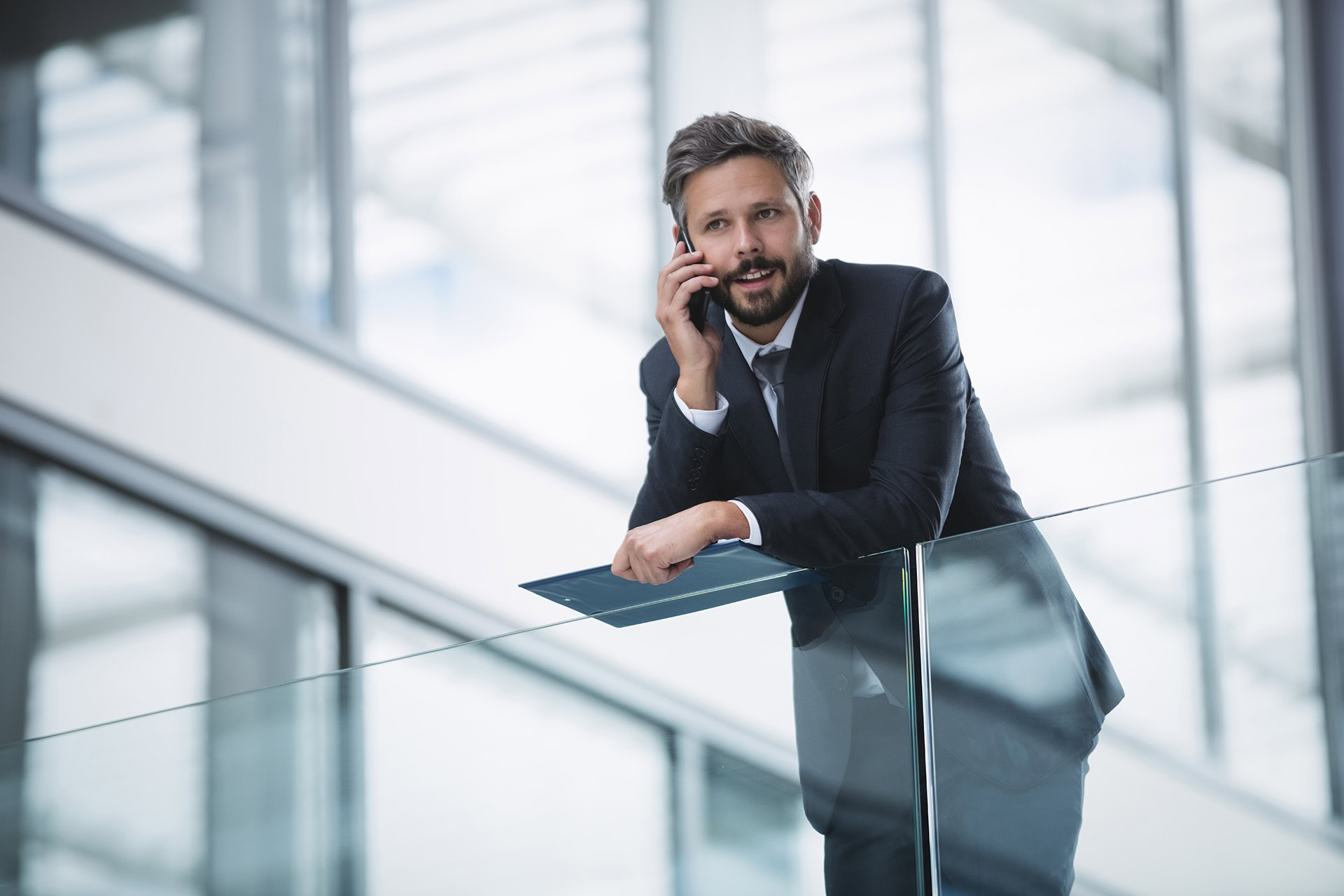 businessman talking on mobile phone inside office building